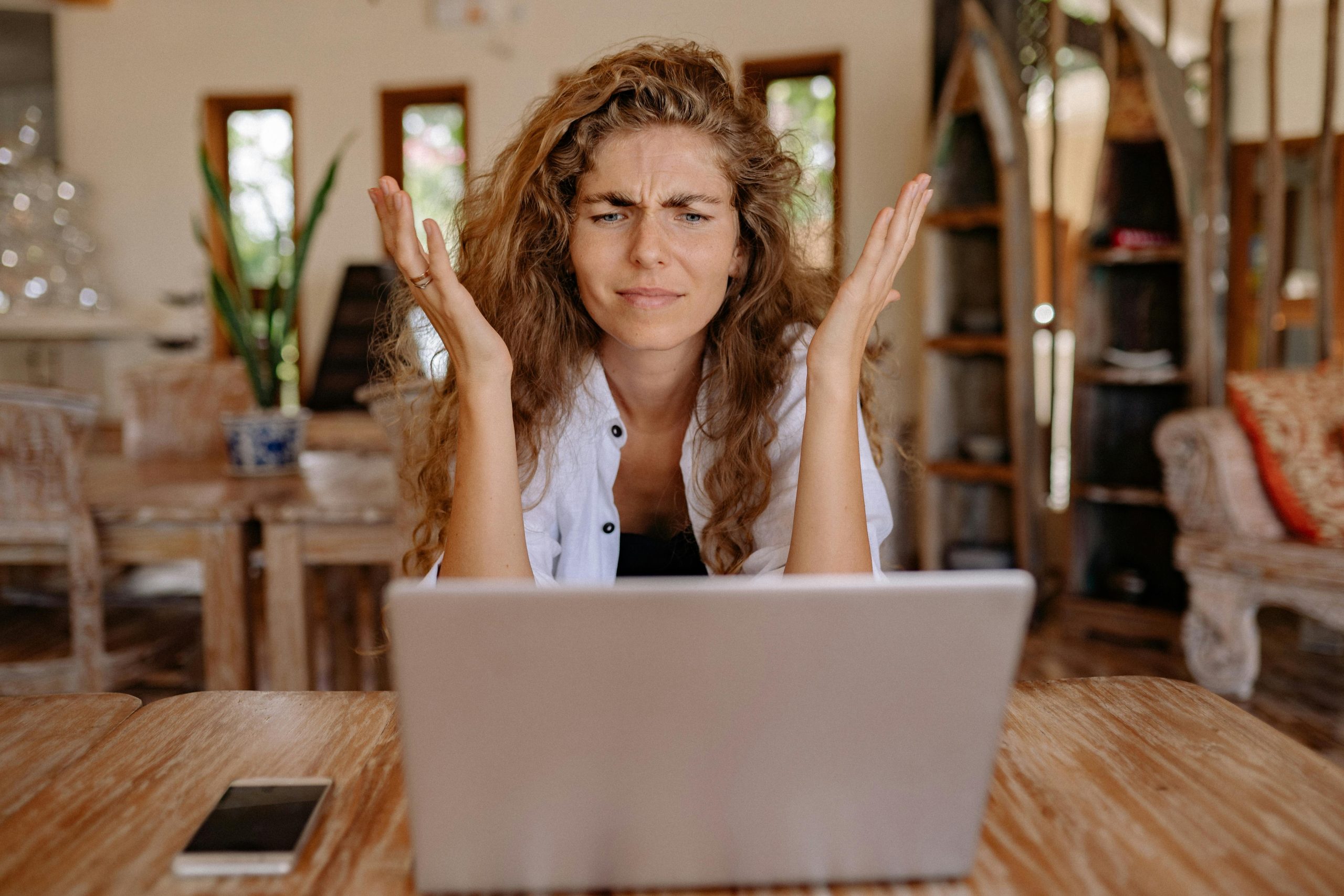 Woman sitting at laptop looking stressed about taxes