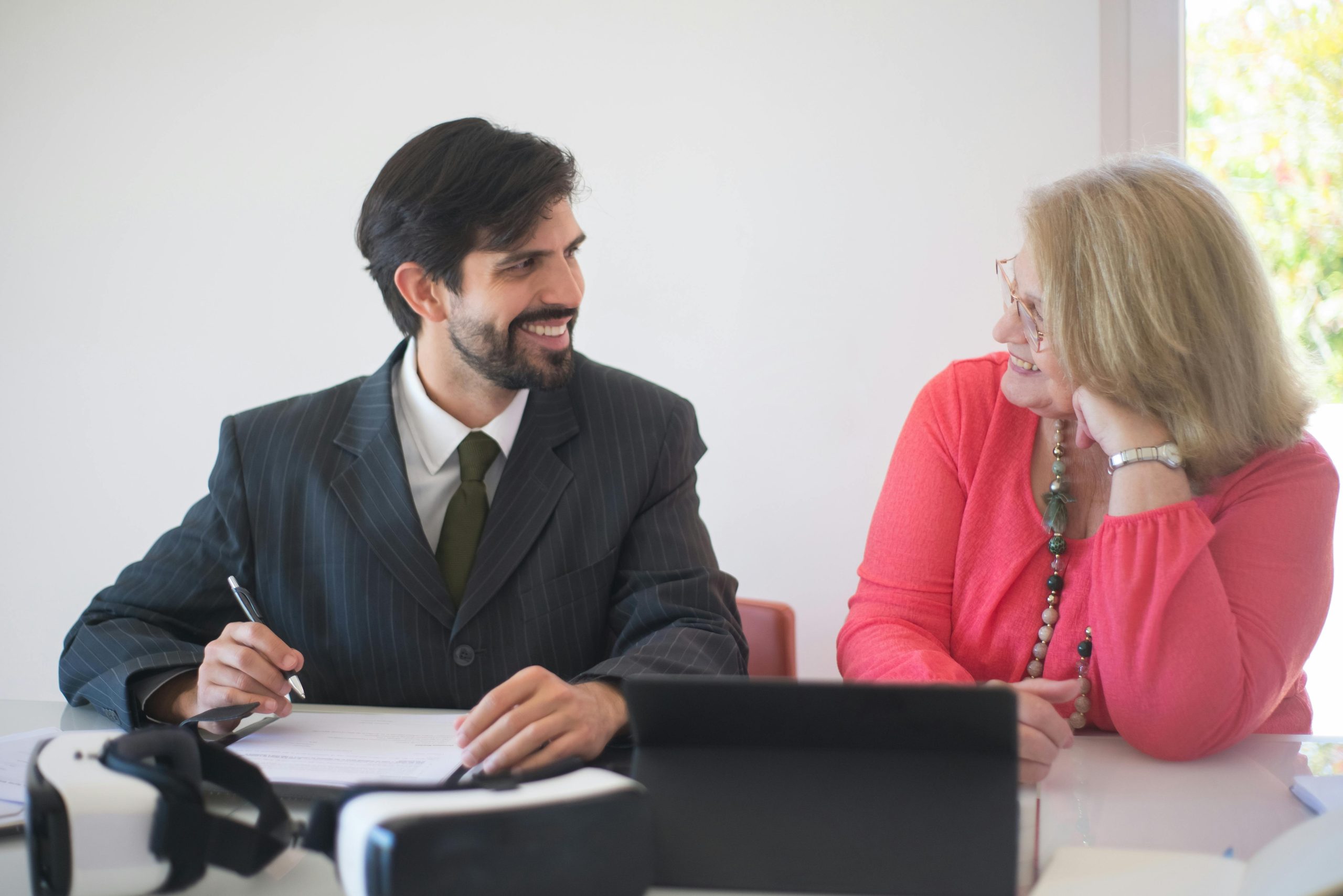 Woman smiling beside her laptop showcasing client success