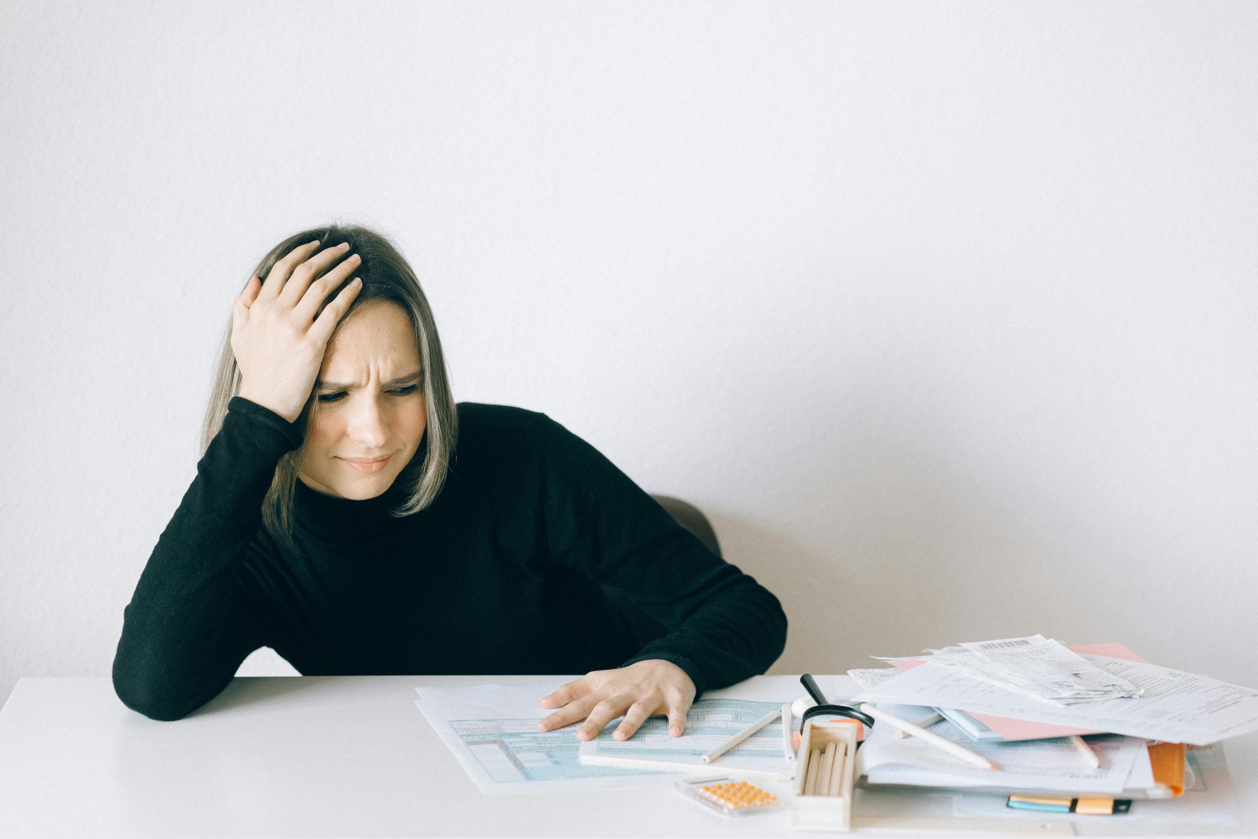 A student looking overwhelmed by textbooks on tax planning