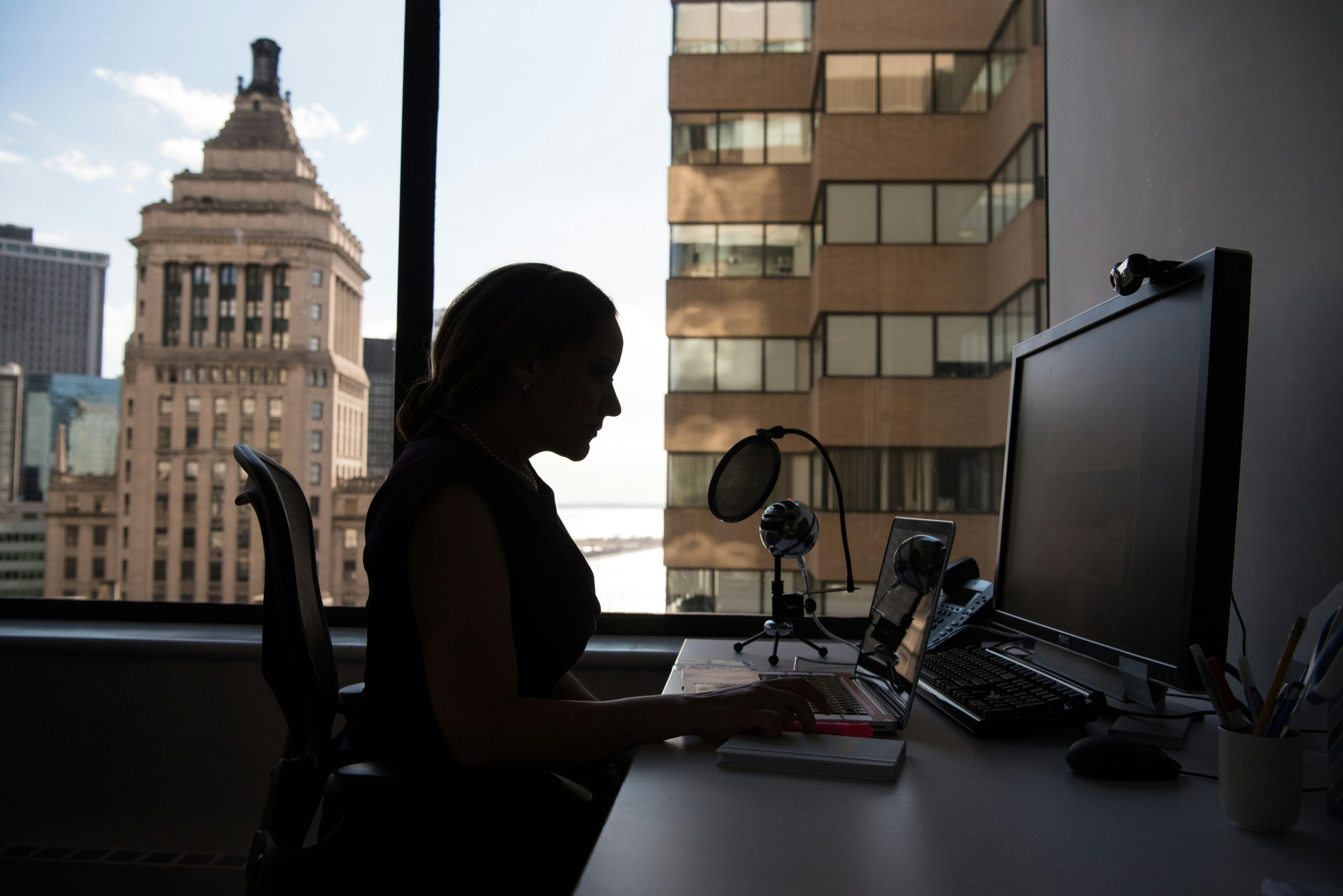 Jane working at her desk while reviewing her improved tax return