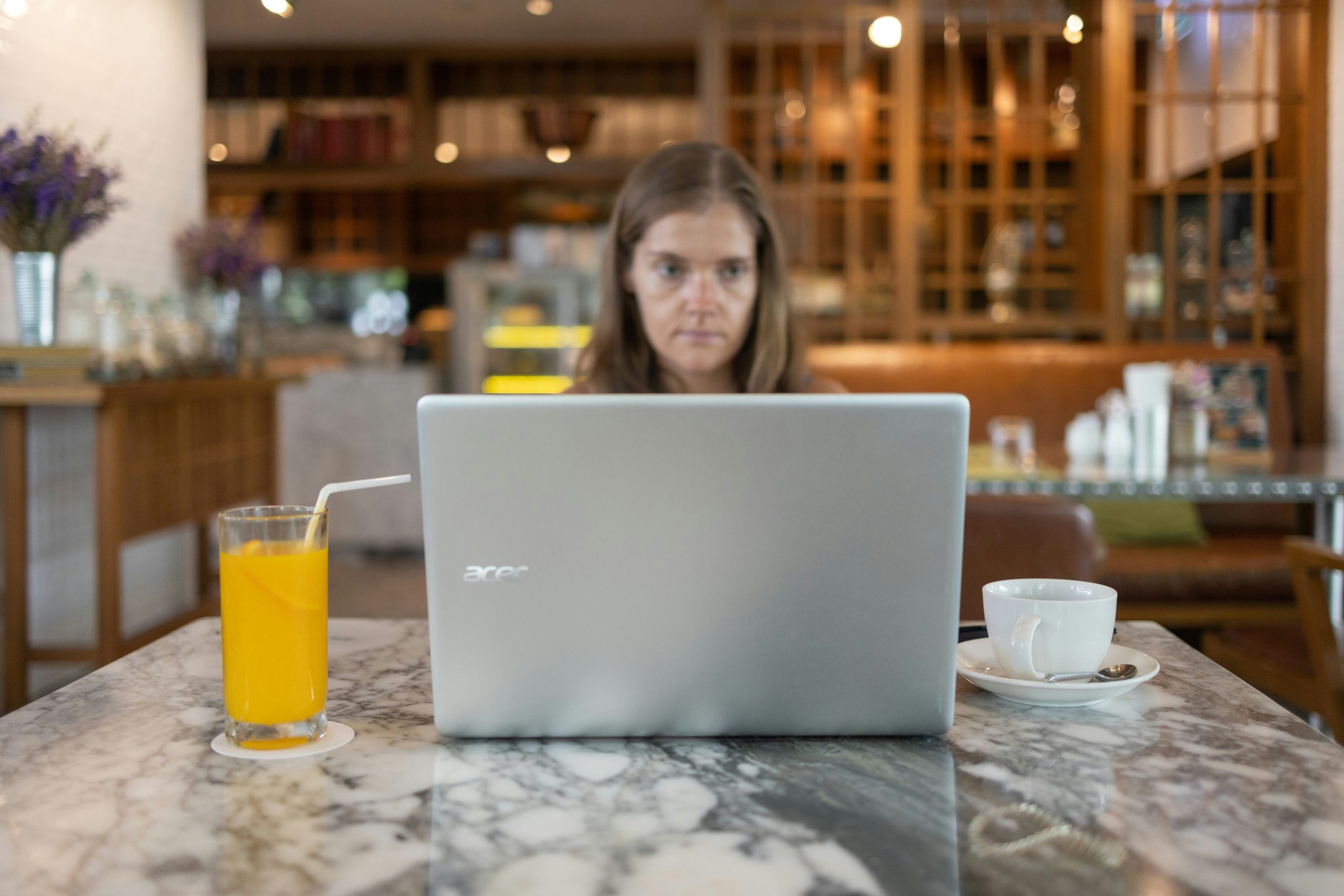 Person looking stressed at laptop filled with tax forms
